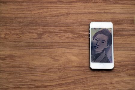 Mobile money payment and cashless concept, Chinese Yuan cash in smartphone, fintech business backgroundの写真素材