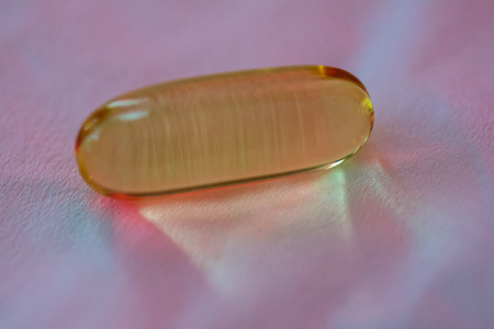 Fish oil capsule close up on tissue backgroundの写真素材