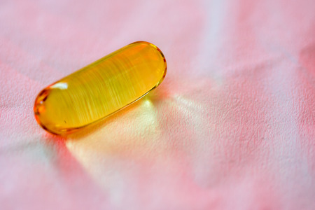 Fish oil capsule close up on tissue backgroundの写真素材