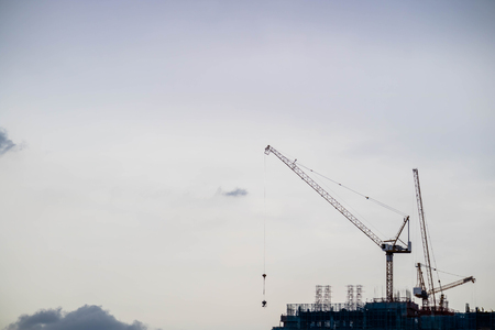Crane and construction site building with twilight evening skyの写真素材