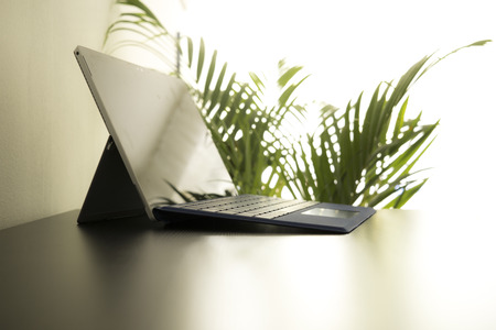 convertible laptop or tablet device on a tableの写真素材