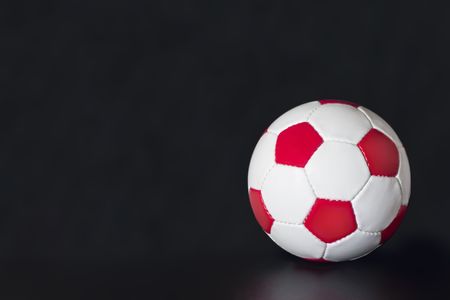 White Soccer Ball with red pentagons and white hexagonsの写真素材