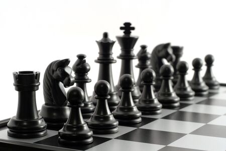 Black chessmen on a chessboardの写真素材