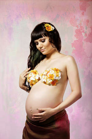 Portrait of pretty pregnant woman on a colored backgroundの写真素材