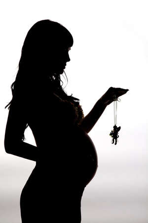Silhouette a beautiful pregnant womanの写真素材