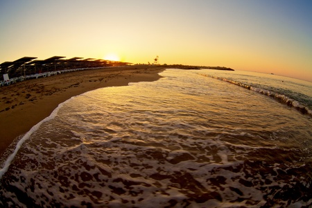 small wave gently swapping on golden tropical beachの写真素材