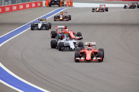Sochi, Russia - October 11, 2015: Kimi Raikkonen Scuderia Ferrari and Valtteri Bottas Williams Martini Racing warming their tires at the race of Formula One Russian Grand Prix at Sochi Autodrom.のeditorial素材