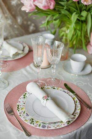 Decor and spring table setting is a vase with pink tulipsの写真素材