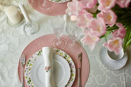 Decor and spring table setting is a vase with pink tulipsの写真素材