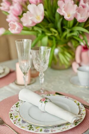 Decor and spring table setting is a vase with pink tulipsの写真素材