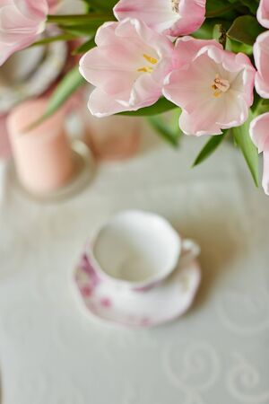 Decor and spring table setting is a vase with pink tulipsの写真素材