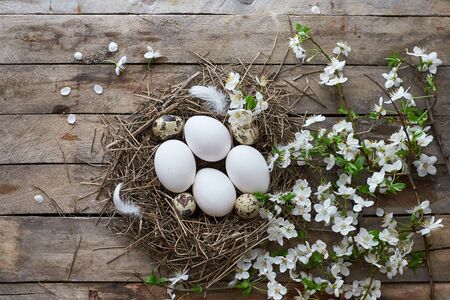 Easter decorations and black board on wooden background.の写真素材
