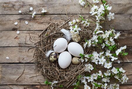 Easter decorations and black board on wooden background.の写真素材