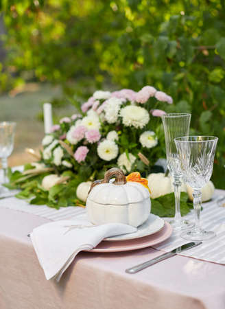 Table setting with beautiful autumn decorand with white mini pumpkinsの写真素材