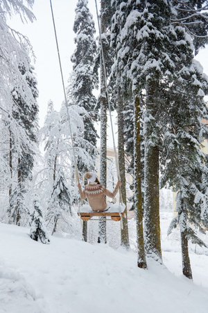 Young girl swinging on a long swingの写真素材