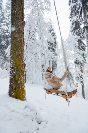 Young girl swinging on a long swingの写真素材