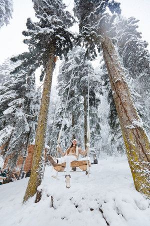 Young girl swinging on a long swingの写真素材