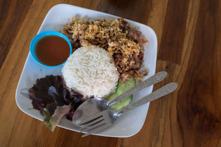 fried pork with garlic and pepper on riceの写真素材