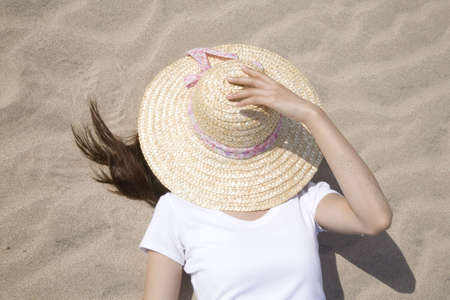 Japanese woman lying on a beachの写真素材