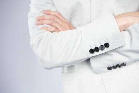 Hand of office worker folding his armsの写真素材