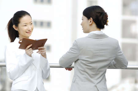 Business ladies who rests at the rooftopの写真素材