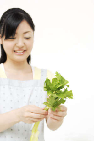 Woman having celeryの写真素材