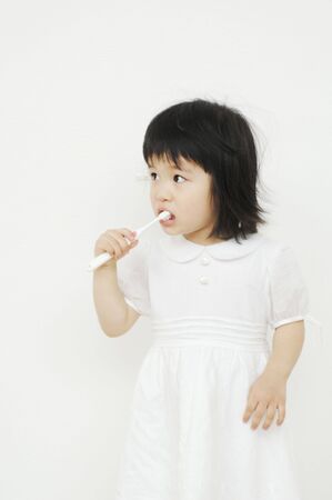 Girl brushing her teethの写真素材