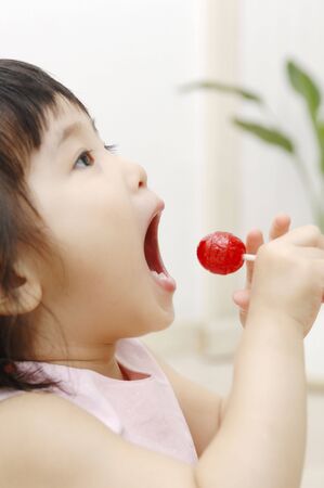 Infant who eats a candyの写真素材