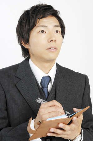 Businessman writing a schedule to the notebookの写真素材