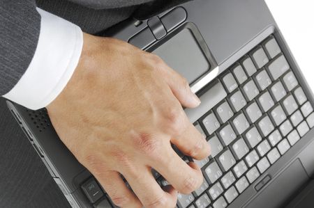 Hand of a man hitting the keyboard of the laptop PCの写真素材