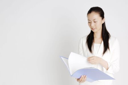 Business lady checking a fileの写真素材
