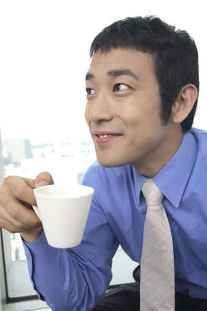 Businessman drinking a cup of coffeeの写真素材