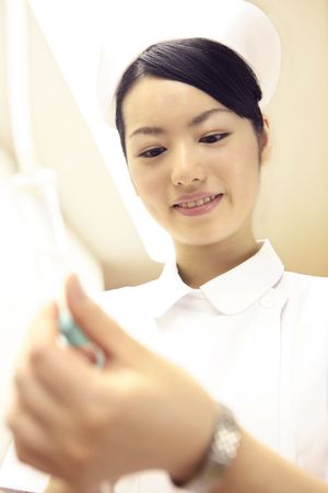 Nurse checking intravenous feedingの写真素材