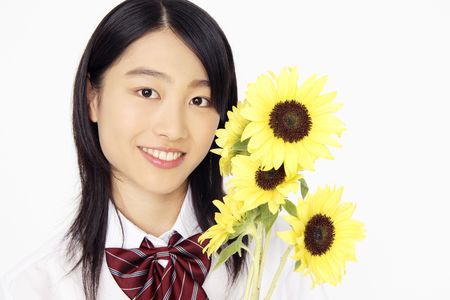 High school girl having sunflowersの写真素材