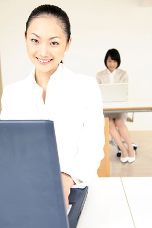 Office lady operating a PCの写真素材