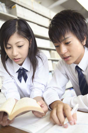 High school sutudent studying in a libraryの写真素材