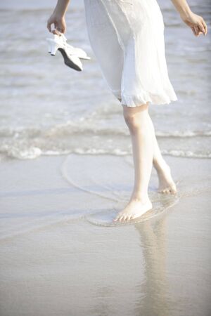 Foot of Japanese woman on the beachの写真素材