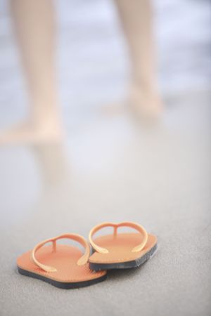 Sandals left on sandy beachの写真素材