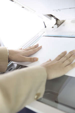 Hand of Japanese office lady taking a copyの写真素材