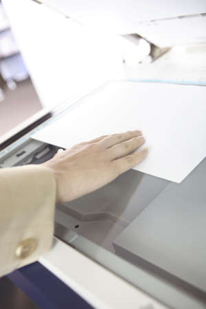 Hand of Japanese office lady taking a copy