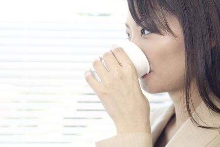 Office lady drinking a waterの写真素材