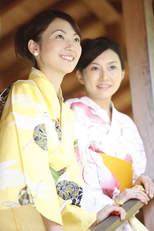 Japanese woman putting on a yukataの写真素材