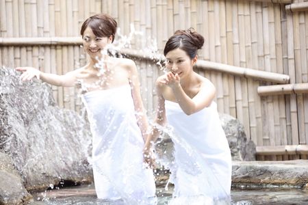 Japanese women scooping a hot water of spaの写真素材
