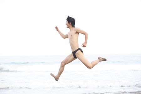 Japanese young man jumpingの写真素材