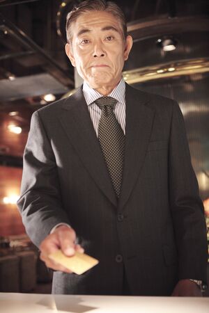 Japanese executive checking by credit cardの写真素材