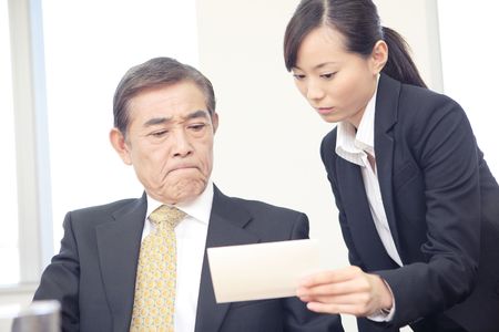 Japanese executive looking at a memoの写真素材