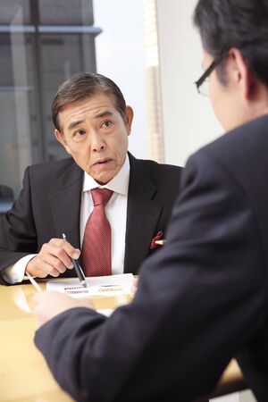Japanese executive having a meetingの写真素材