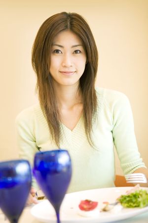 Woman having a meal at a restaurantの写真素材