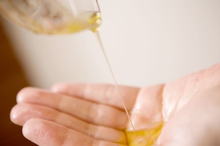 Palm of the hand receiving oil
