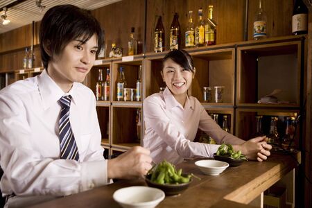 Office workers waiting for service at barの写真素材